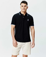 Mens Sunny Pique Polo, a classic fit black pique polo shirt with light blue and white striped collar and sleeve cuffs, featuring a small embroidered Psycho Bunny skull logo on the left chest.