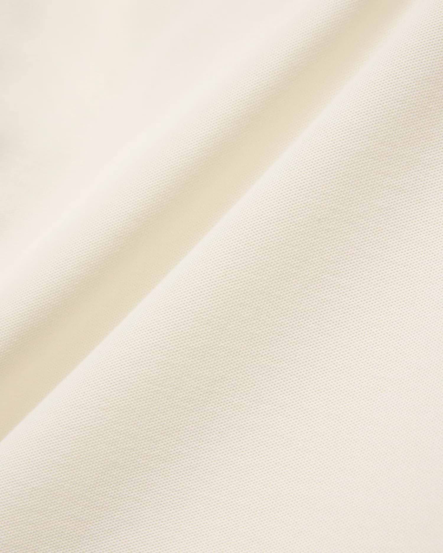 Mens Sunny Pique Polo in a rich cream hue, featuring a finely textured, breathable pique knit fabric, characteristic of Psycho Bunny's refined, comfortable menswear.