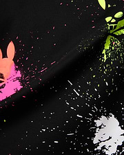 Mens Quintin Aop Pique Polo in black pique fabric, showcasing a bold all-over paint splatter print in neon pink, green, and white, with integrated Psycho Bunny skull logos.