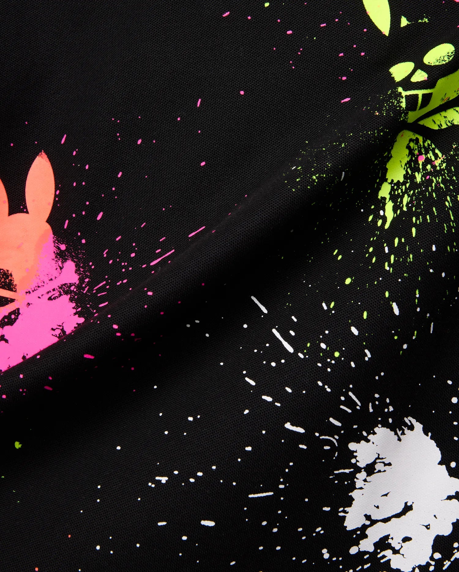 Mens Quintin Aop Pique Polo in black pique fabric, showcasing a bold all-over paint splatter print in neon pink, green, and white, with integrated Psycho Bunny skull logos.