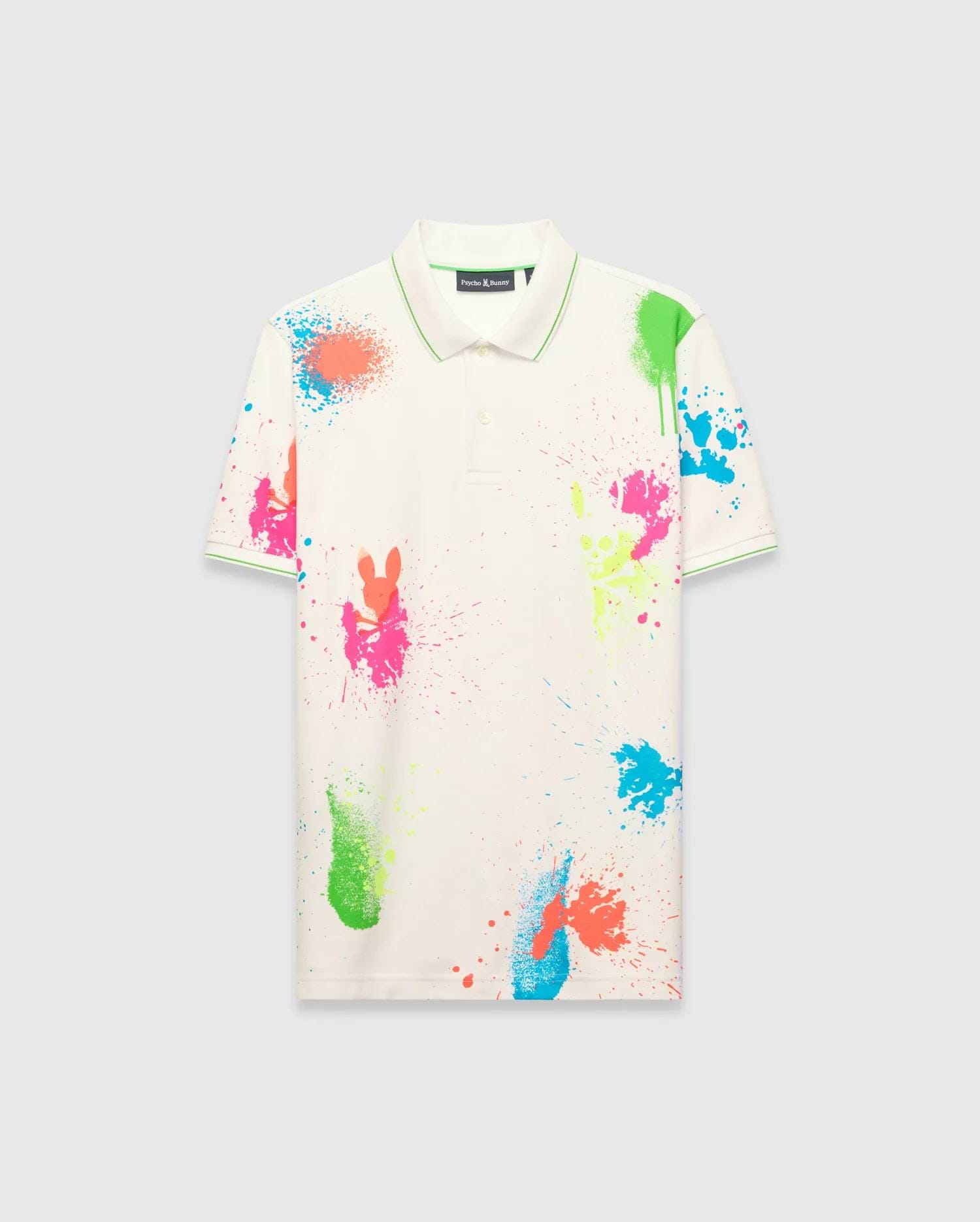 Mens Quintin Aop Pique Polo, off-white classic fit pique polo with vibrant neon paint splatter print featuring bunny skull silhouettes, green tipping on collar and cuffs, and a small embroidered Psycho Bunny logo on the left chest.