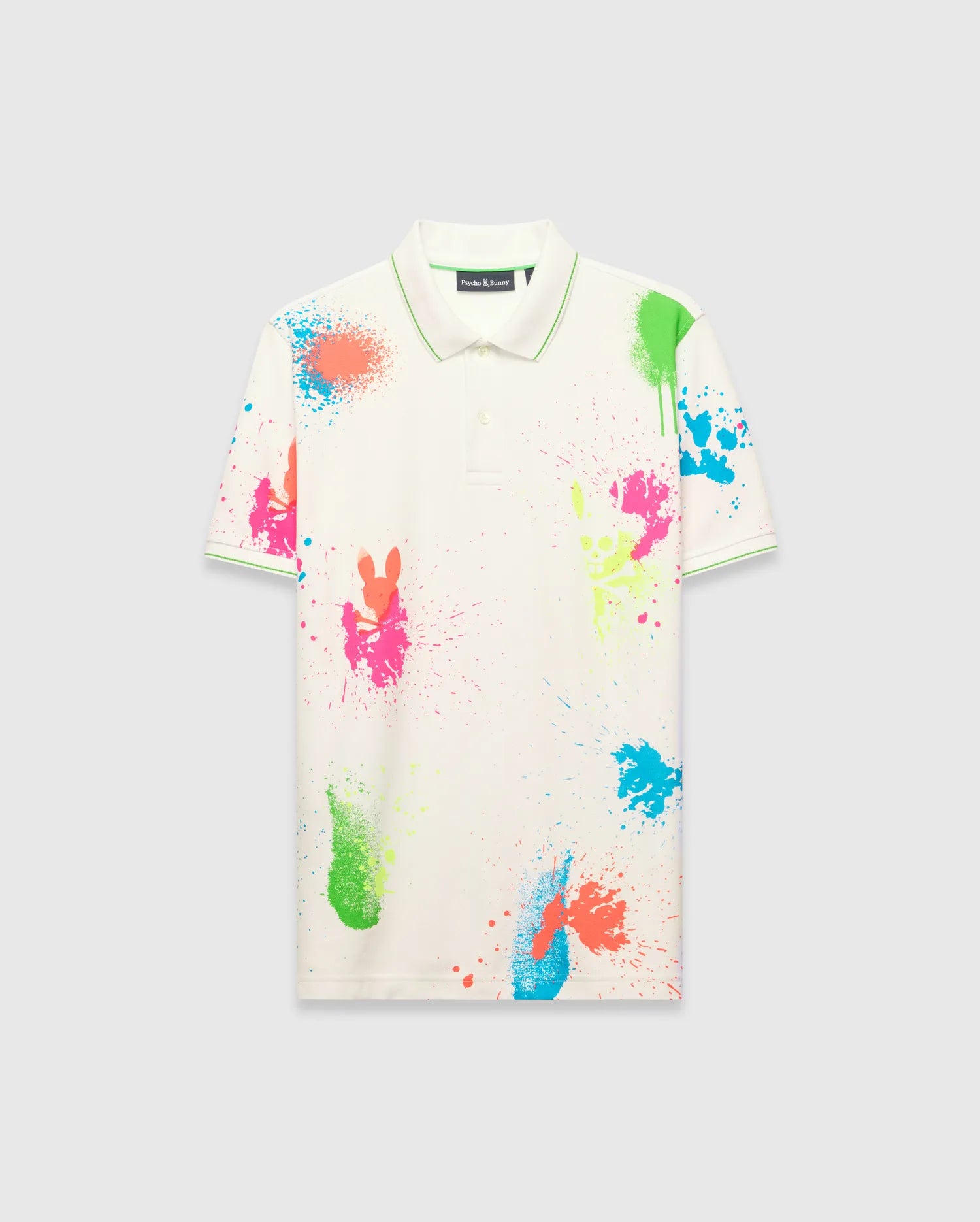 Mens Quintin Aop Pique Polo, off-white classic fit pique polo with vibrant neon paint splatter print featuring bunny skull silhouettes, green tipping on collar and cuffs, and a small embroidered Psycho Bunny logo on the left chest.