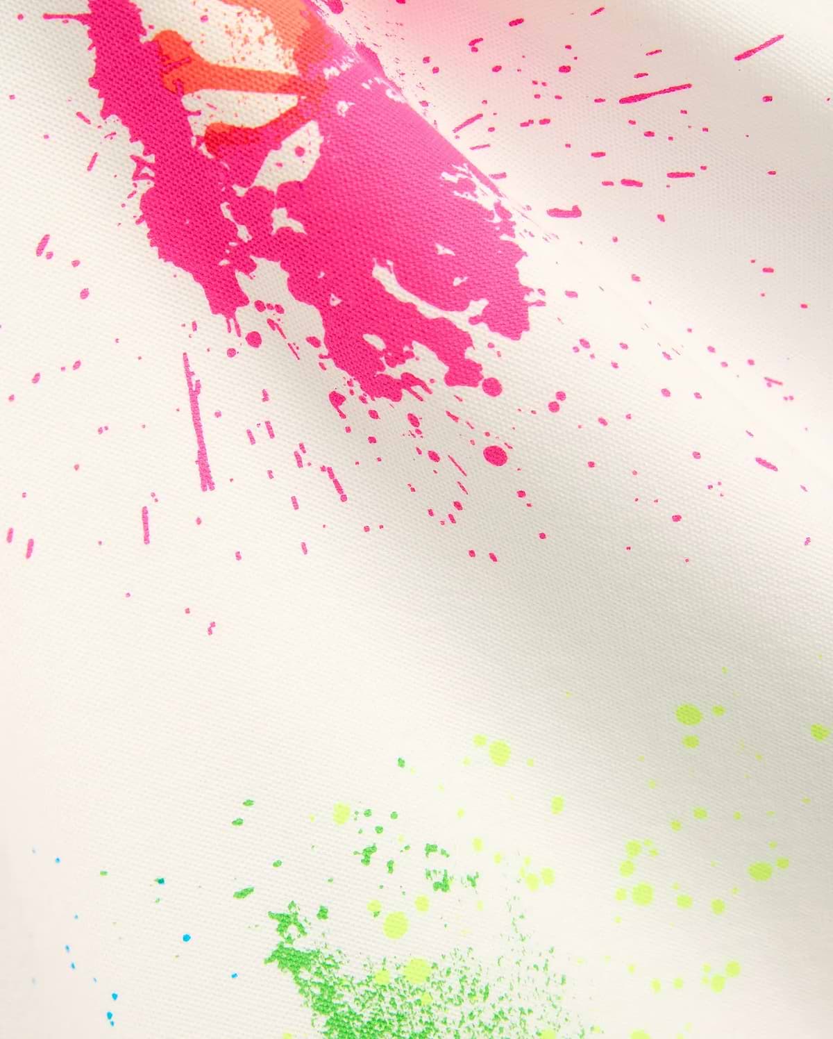 Mens Quintin Aop Pique Polo in crisp white pique fabric, adorned with a bold all-over paint splatter print in vibrant hot pink, neon green, bright orange, and subtle light blue.