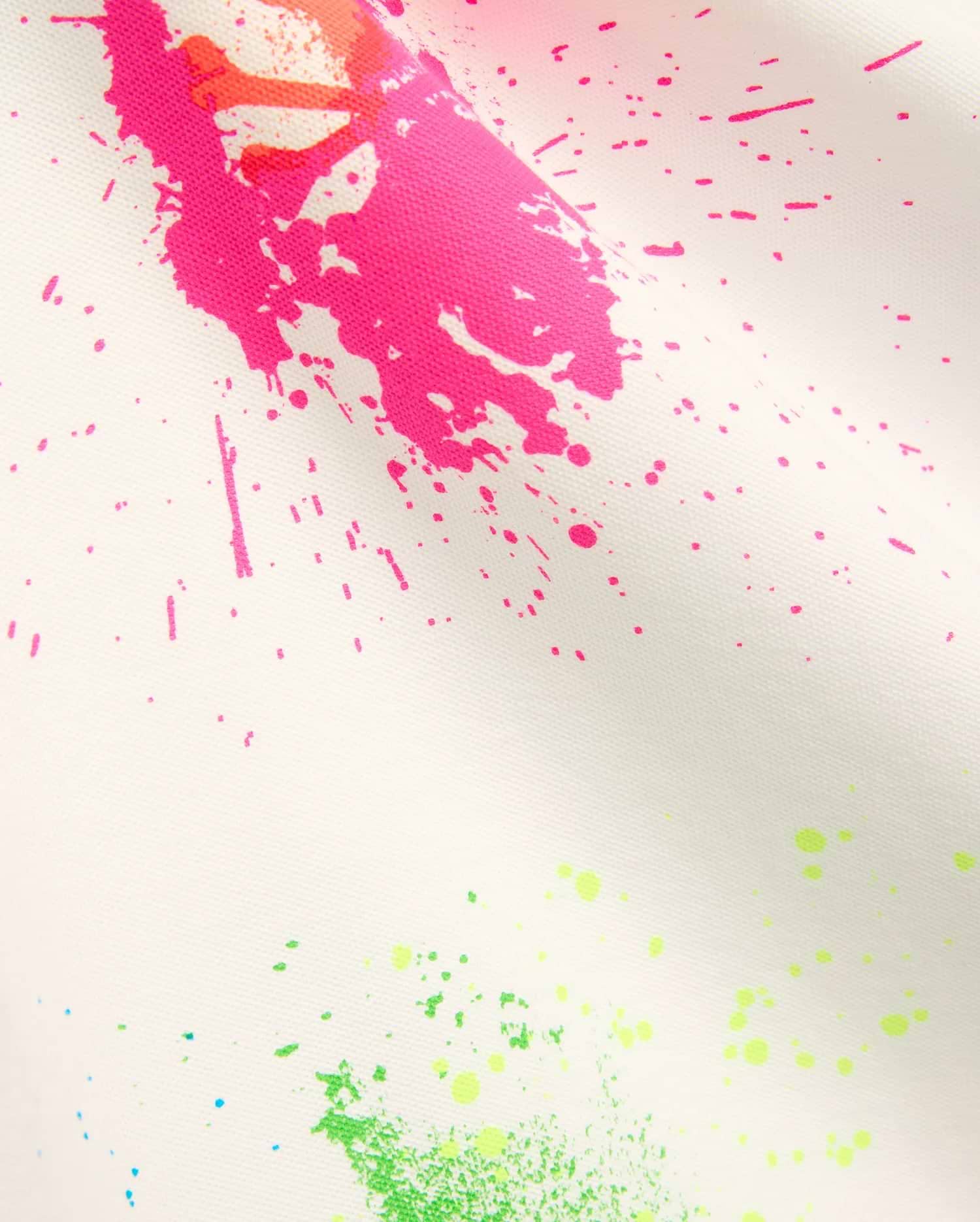 Mens Quintin Aop Pique Polo in crisp white pique fabric, adorned with a bold all-over paint splatter print in vibrant hot pink, neon green, bright orange, and subtle light blue.