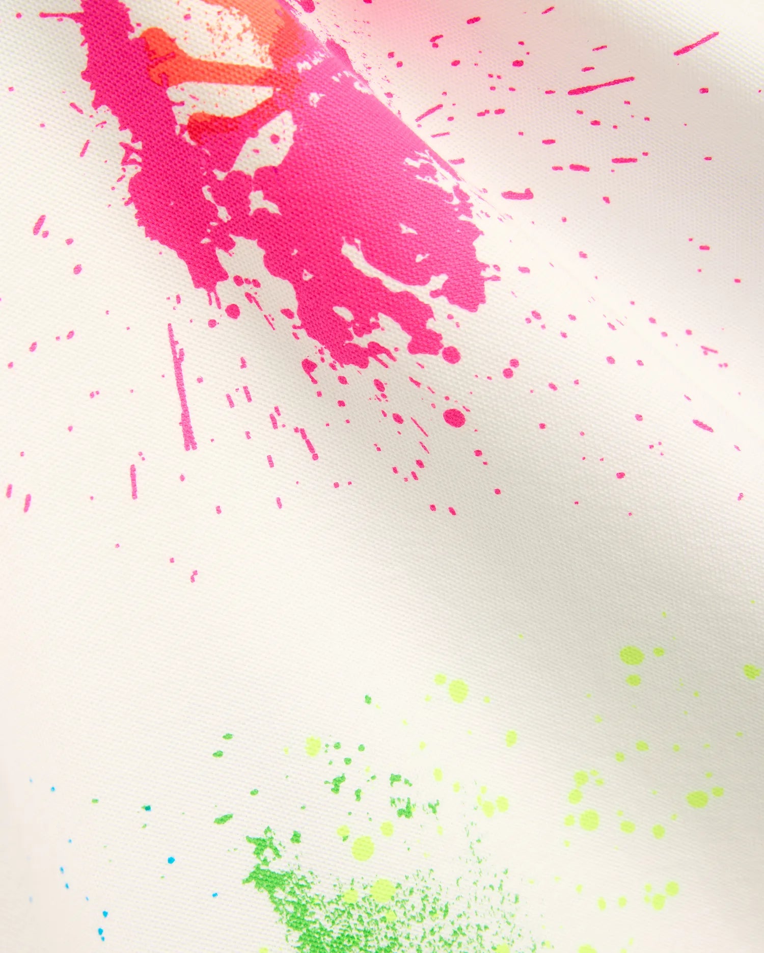 Mens Quintin Aop Pique Polo in crisp white pique fabric, adorned with a bold all-over paint splatter print in vibrant hot pink, neon green, bright orange, and subtle light blue.