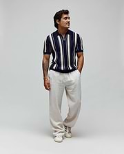 Mens Cliff Knit Zip Polo, a classic fit navy and cream vertical striped textured knit polo with a half-zip and embroidered Psycho Bunny skull logo on the left chest. (3)