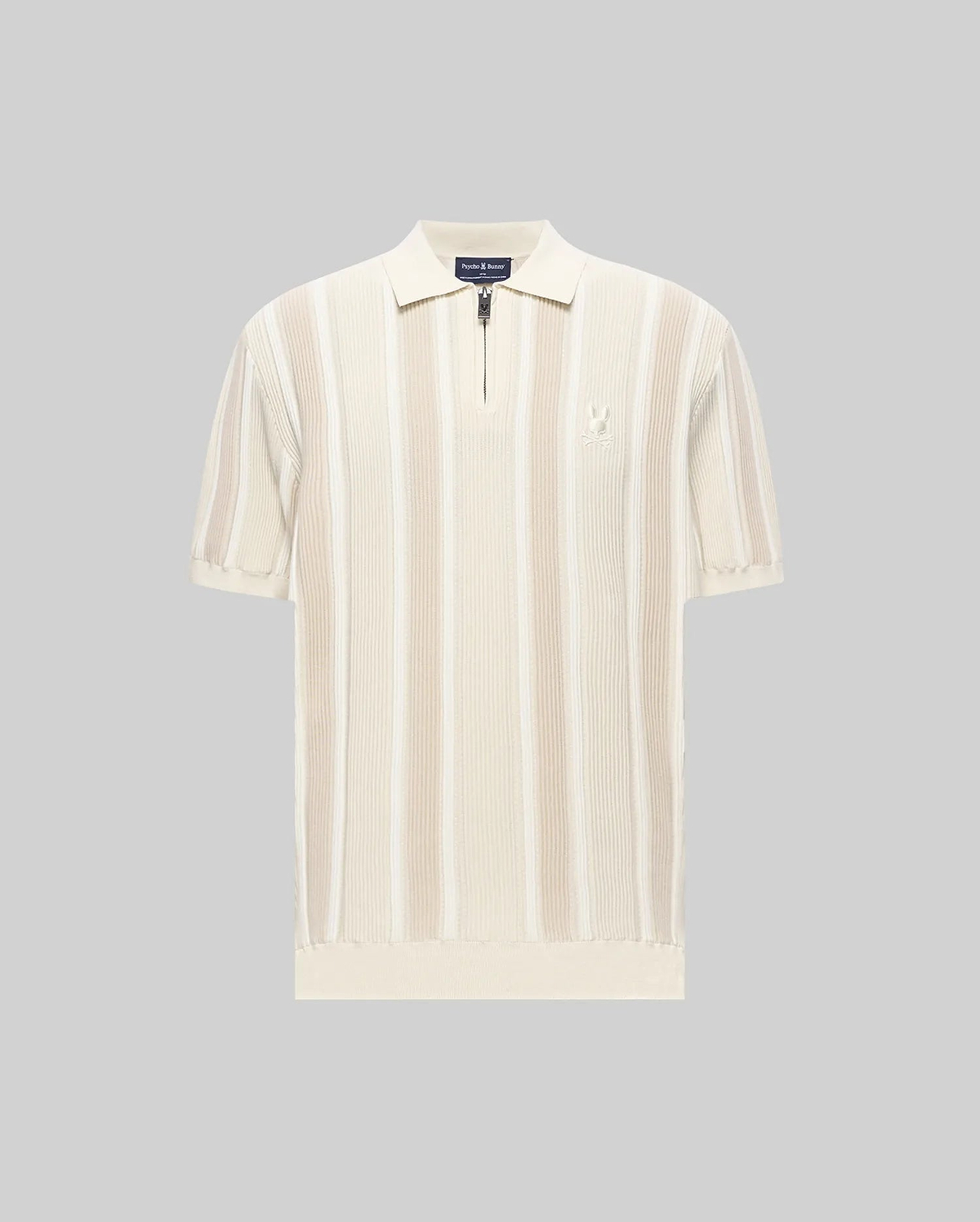 Mens Cliff Knit Zip Polo in cream with lighter cream vertical stripes, featuring a ribbed knit texture, quarter-zip placket, classic fit, and a small embroidered Psycho Bunny skull logo on the left chest.