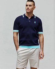 Mens Dax Knit Polo, navy classic fit knit polo with aqua and white striped ribbed collar, cuffs, and hem, featuring a small embroidered aqua Psycho Bunny skull logo on the left chest. (3)