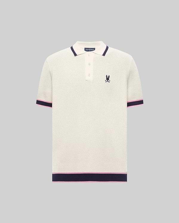 Mens Dax Knit Polo, cream textured knit with navy and pink striped ribbed collar, cuffs, and hem, featuring a small embroidered navy Psycho Bunny skull logo on the left chest.