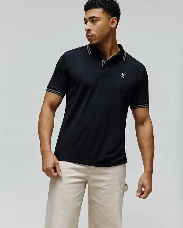 Mens Kenyon Lightweight Pique Polo, black classic fit with white double-stripe tipping on collar and cuffs, featuring a small embroidered white Psycho Bunny skull logo on the left chest.
