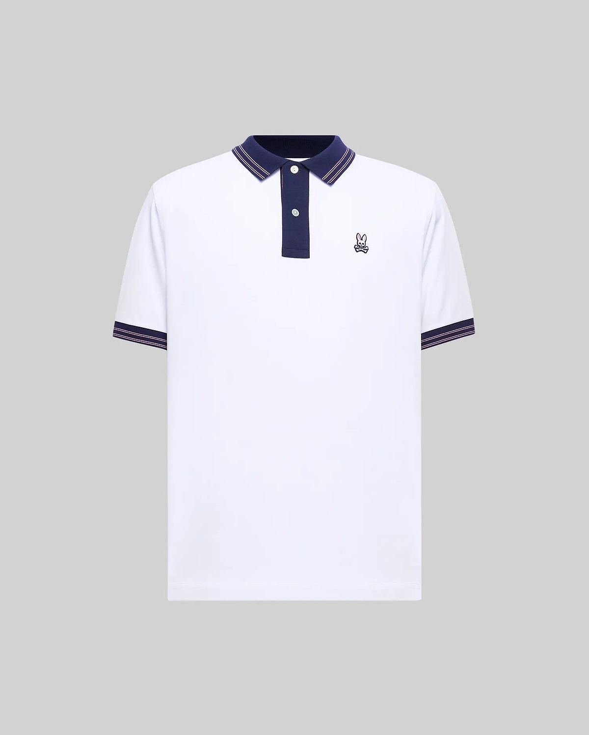 Mens Kenyon Lightweight Pique Polo, white with navy blue collar and placket, featuring pink striped tipping on collar and sleeve cuffs, and a small embroidered Psycho Bunny skull logo on the left chest.