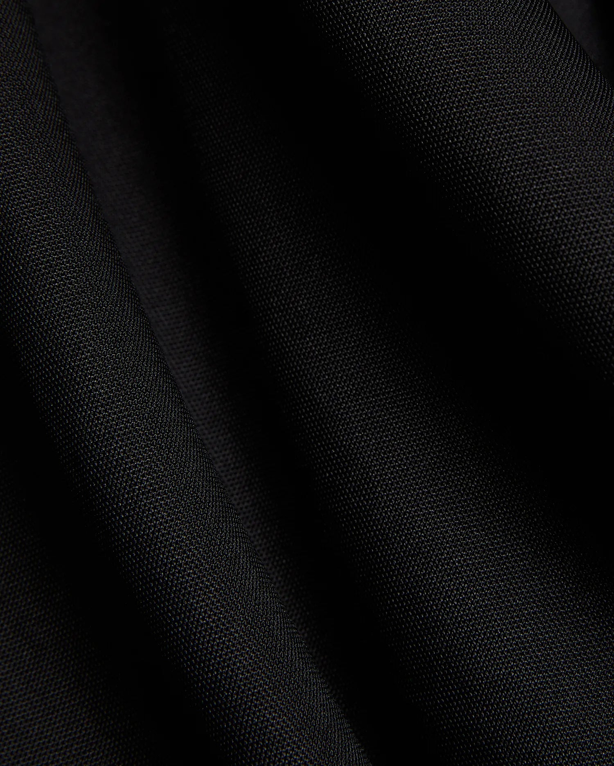 Mens Odin Zip Sport Polo in a rich black, featuring a visible premium pique knit fabric texture, characteristic of Psycho Bunny's refined streetwear style.