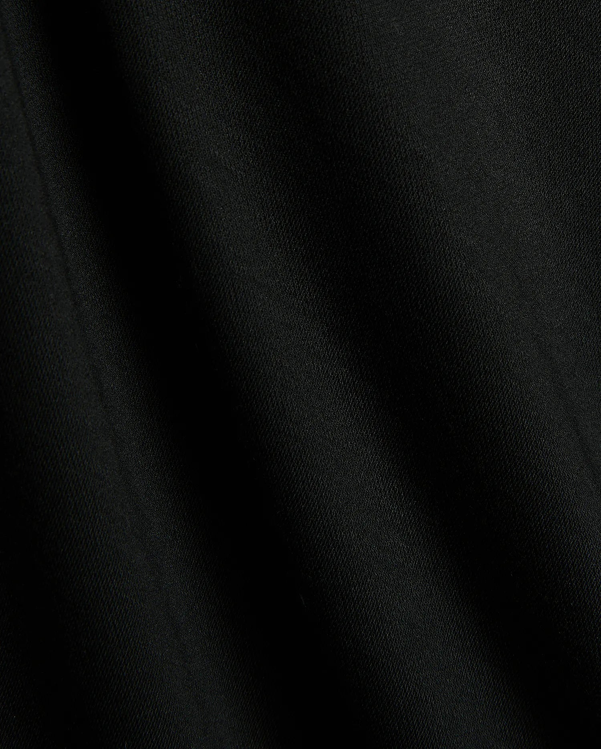 Premium black Mens Timmy Interlock Polo fabric, showcasing a smooth, dense interlock knit with subtle texture and refined drape, embodying Psycho Bunny's sophisticated streetwear style.