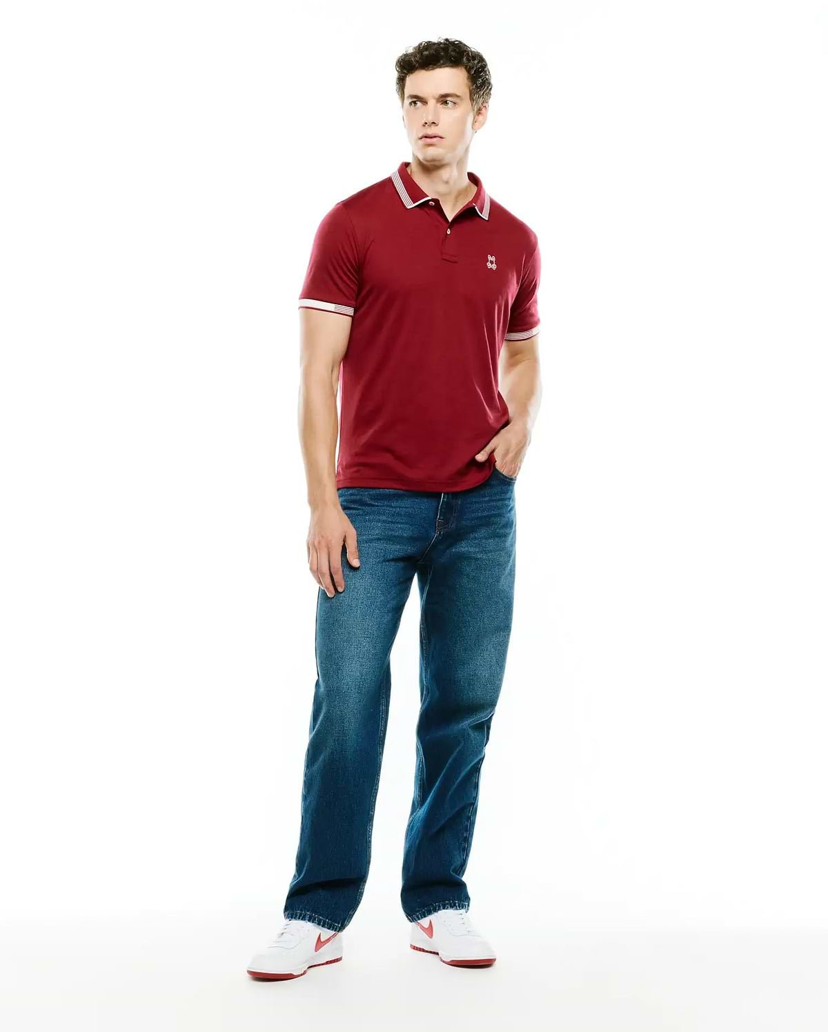 Mens Timmy Interlock Polo, a classic fit maroon interlock knit polo with white tipped collar and cuffs, featuring a small embroidered Psycho Bunny skull logo on the left chest.