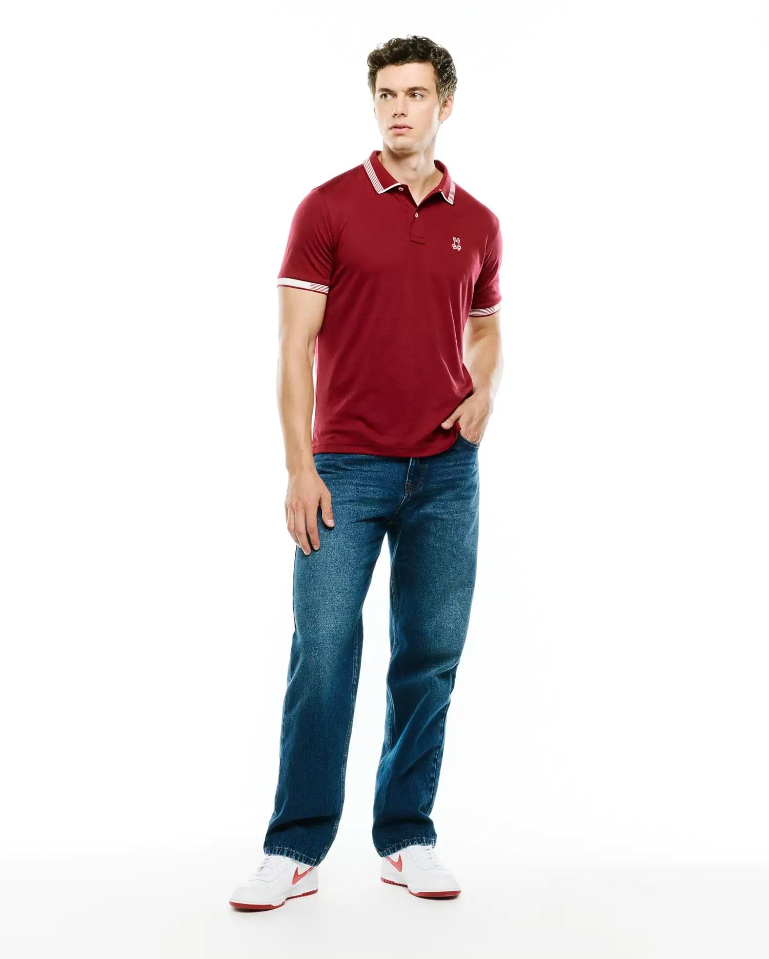 Mens Timmy Interlock Polo, a classic fit maroon interlock knit polo with white tipped collar and cuffs, featuring a small embroidered Psycho Bunny skull logo on the left chest.