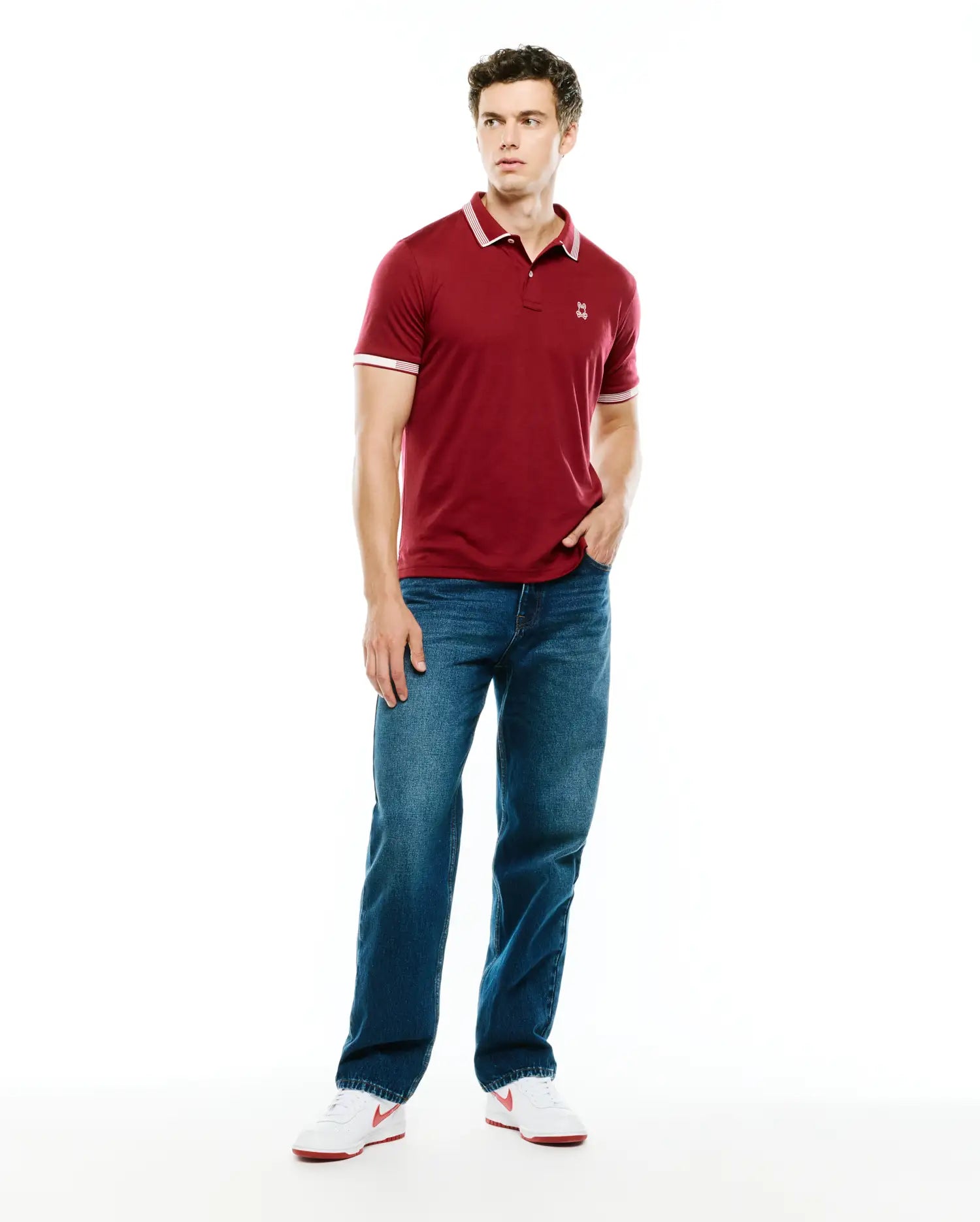 Mens Timmy Interlock Polo, a classic fit maroon interlock knit polo with white tipped collar and cuffs, featuring a small embroidered Psycho Bunny skull logo on the left chest.