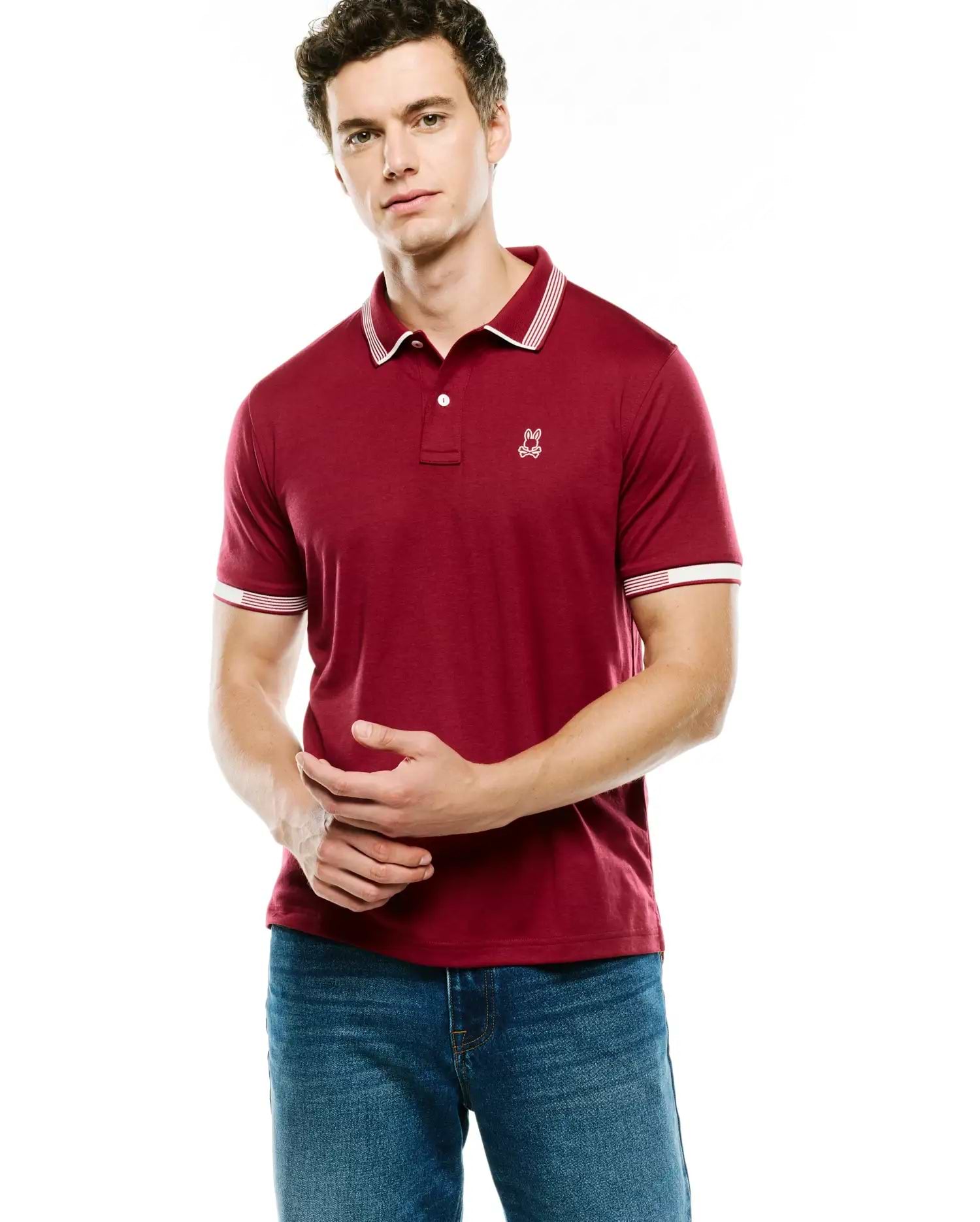 Mens Timmy Interlock Polo in deep maroon, featuring a classic fit, two-button placket, white tipped collar and cuffs, and a small embroidered white Psycho Bunny skull logo on the left chest.