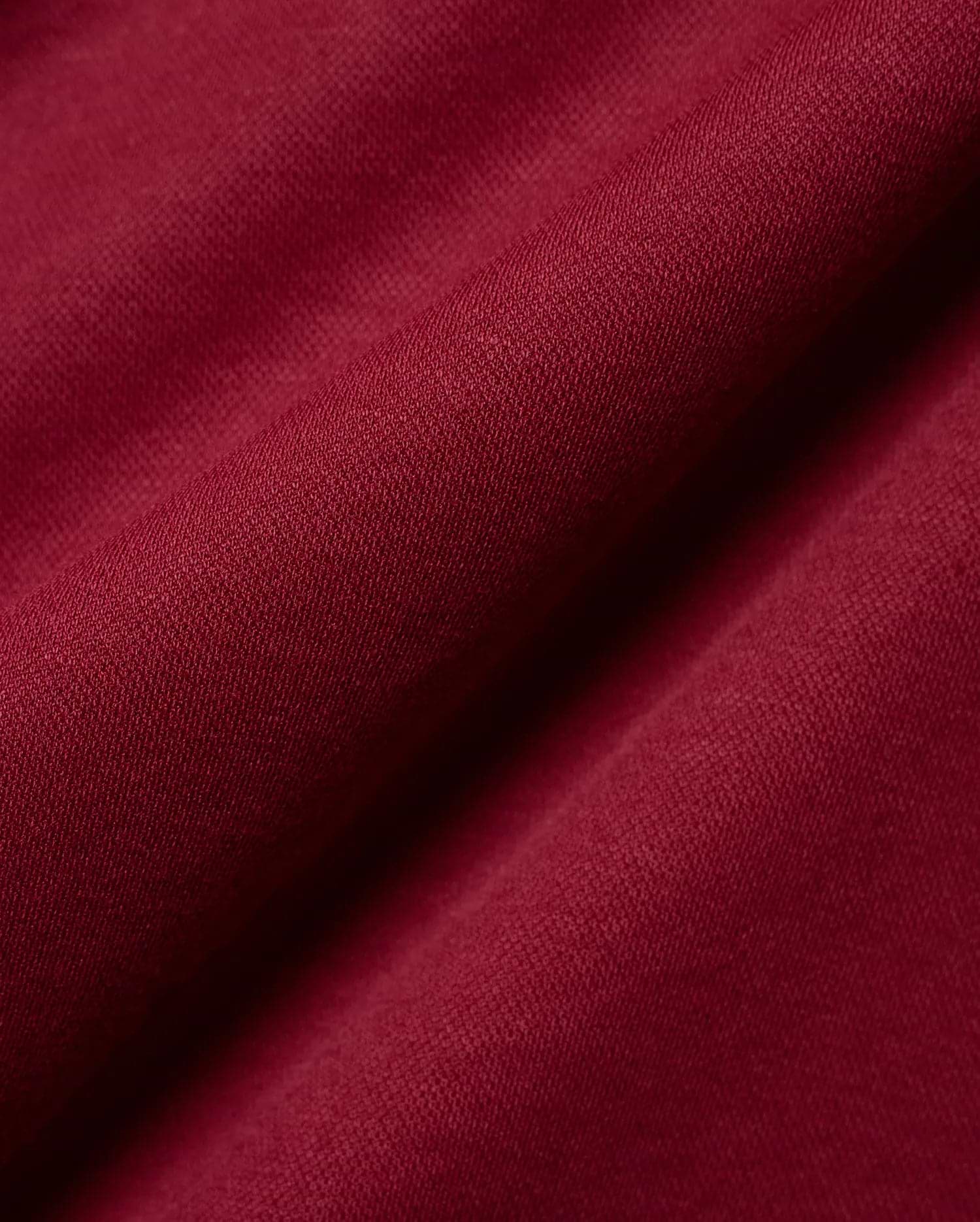 Mens Timmy Interlock Polo in a luxurious deep burgundy, highlighting the premium, smooth interlock knit fabric with its refined, subtle texture and elegant, soft drape.