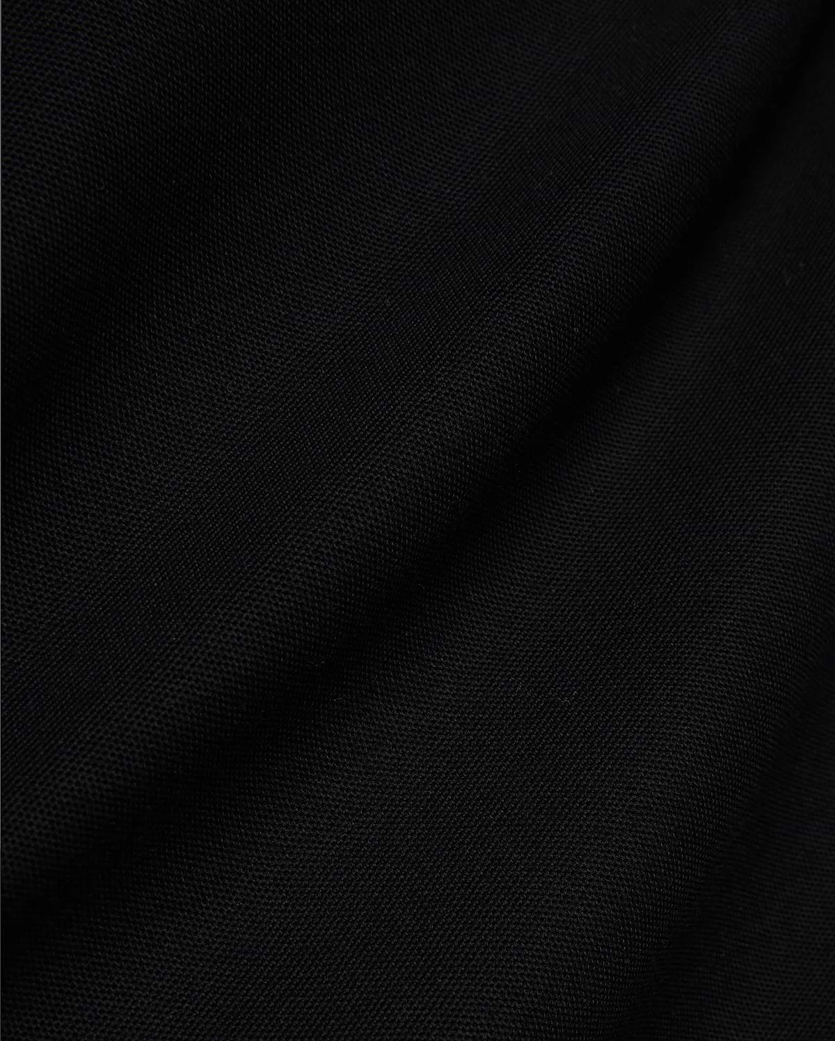 Mens Jaydon Pique Polo, a luxurious black polo crafted from premium, finely woven pique fabric, showcasing its distinctive texture and subtle draping, embodying Psycho Bunny's sophisticated style.