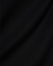 Mens Jaydon Pique Polo, a luxurious black polo crafted from premium, finely woven pique fabric, showcasing its distinctive texture and subtle draping, embodying Psycho Bunny's sophisticated style.