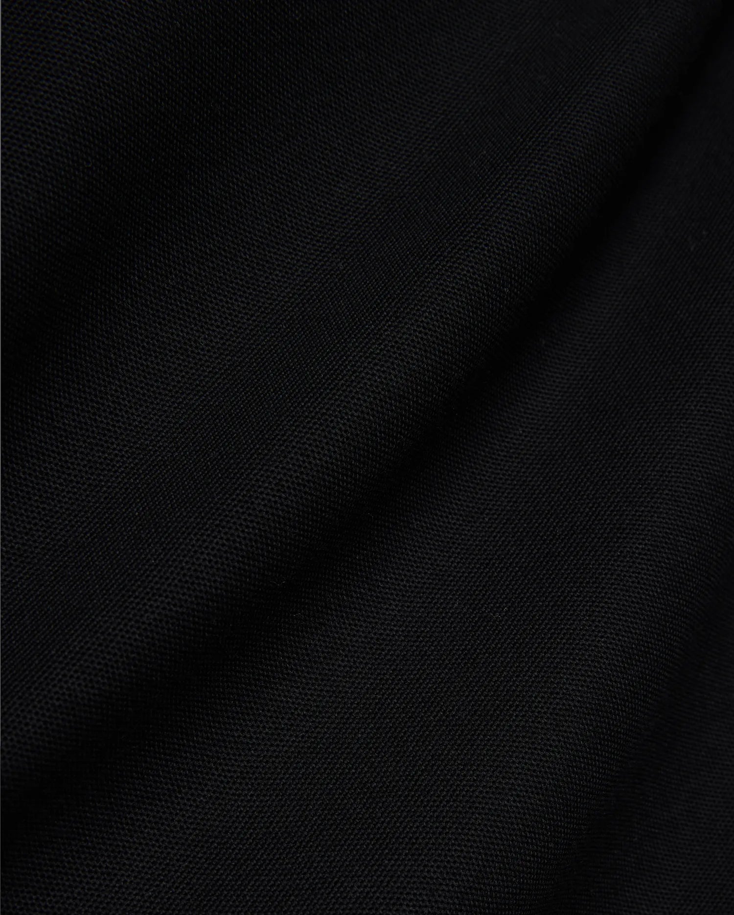 Mens Jaydon Pique Polo, a luxurious black polo crafted from premium, finely woven pique fabric, showcasing its distinctive texture and subtle draping, embodying Psycho Bunny's sophisticated style.