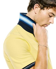 Mens Jaydon Pique Polo in vibrant yellow, featuring a classic fit and textured pique fabric. It has a distinctive striped collar and sleeve cuffs with navy, blue, and white accents.