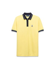 Mens Jaydon Pique Polo in bright yellow, featuring a navy blue collar with white tipping, a two-button placket, ribbed cuffs with matching stripes, and a small embroidered Psycho Bunny logo on the left chest for a classic fit.