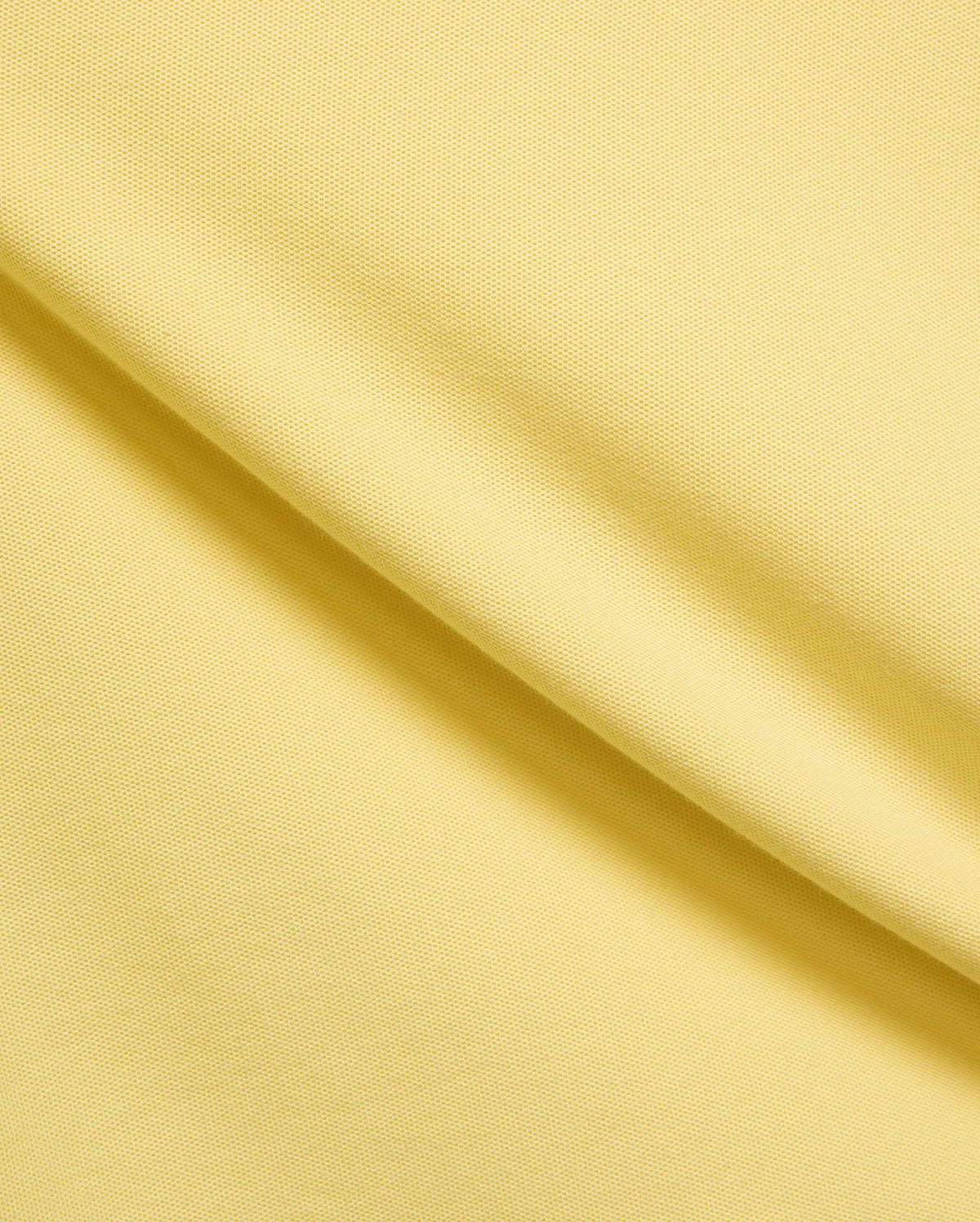 Mens Jaydon Pique Polo in vibrant yellow, showcasing its classic pique texture and the signature small embroidered Psycho Bunny skull logo on the chest.