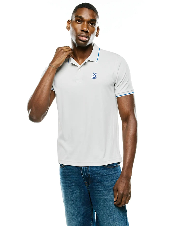 Men's Joji Performance Polo, light grey performance fabric polo with blue tipping on collar and sleeves, featuring a small embroidered blue Psycho Bunny skull logo on the left chest.