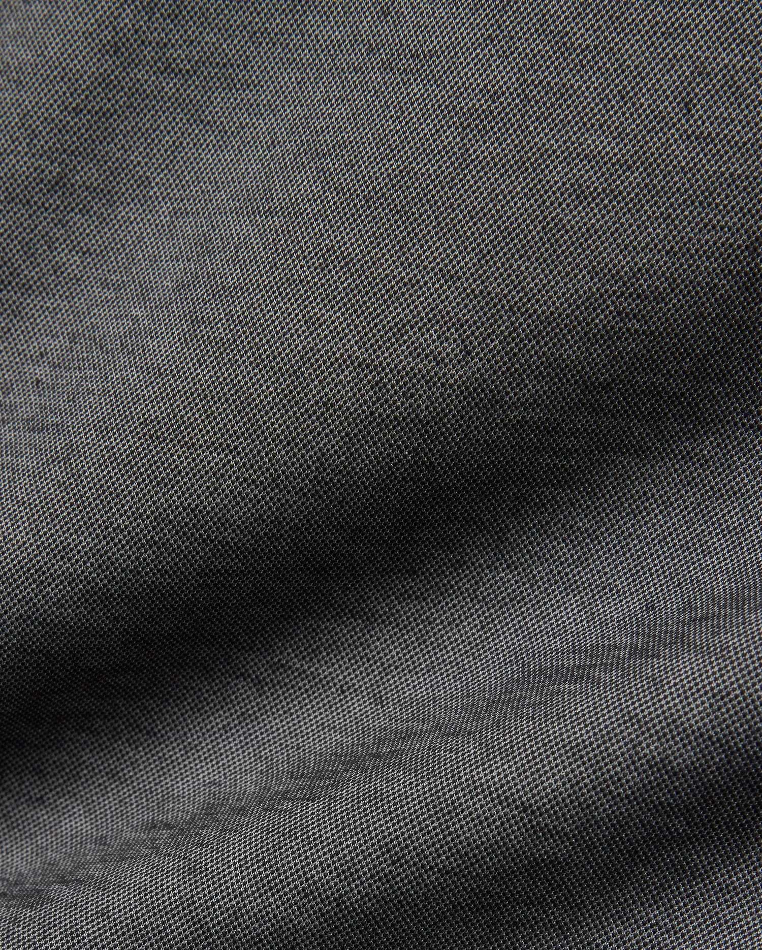 Psycho Bunny MENS JOJI PERFORMANCE POLO in a deep charcoal grey, featuring a premium, subtly textured pique knit fabric, offering a refined streetwear aesthetic and classic fit.