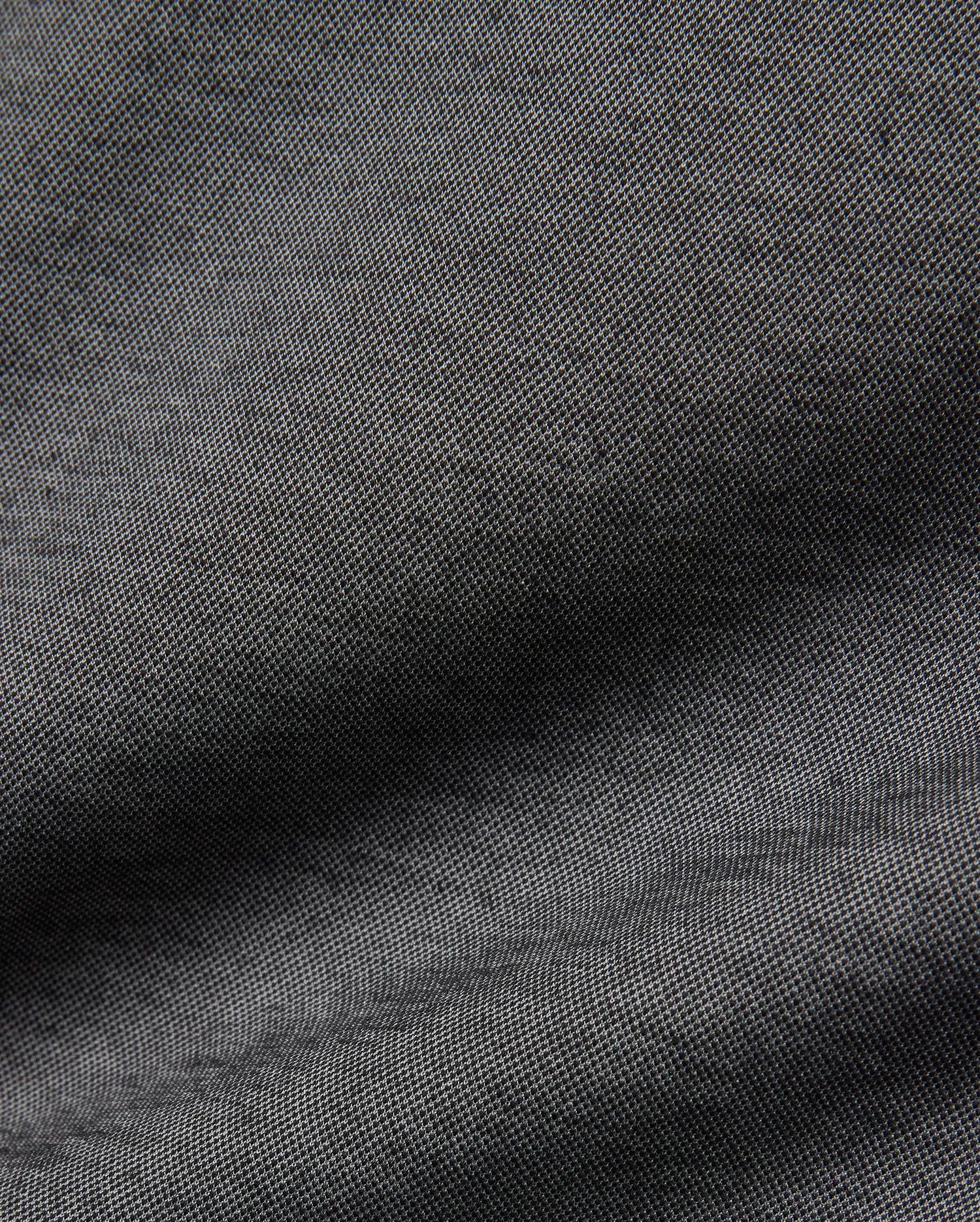 Psycho Bunny MENS JOJI PERFORMANCE POLO in a deep charcoal grey, featuring a premium, subtly textured pique knit fabric, offering a refined streetwear aesthetic and classic fit.