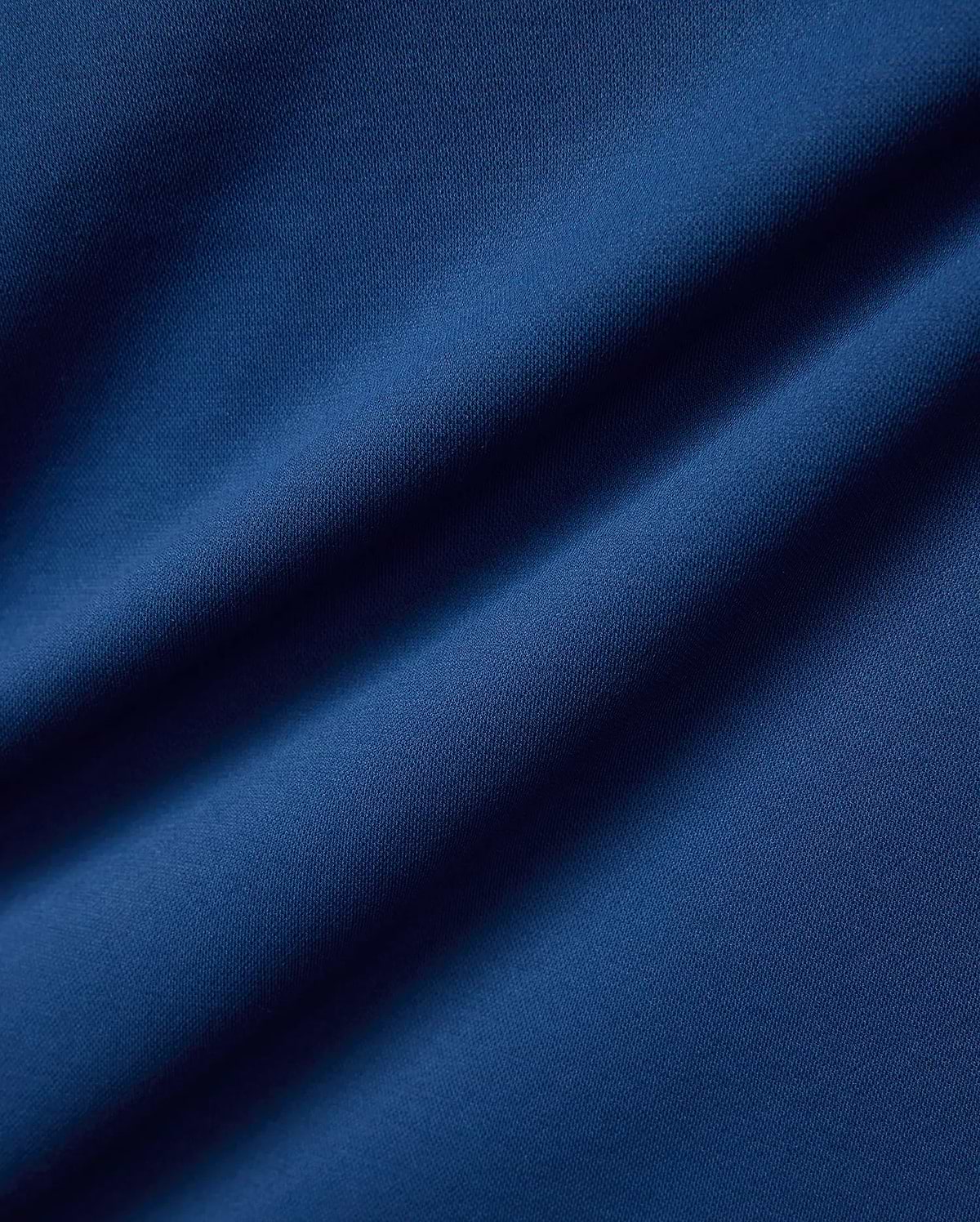 Psycho Bunny Mens Joji Performance Polo in deep blue, featuring a finely textured pique knit fabric, embodying refined streetwear style.