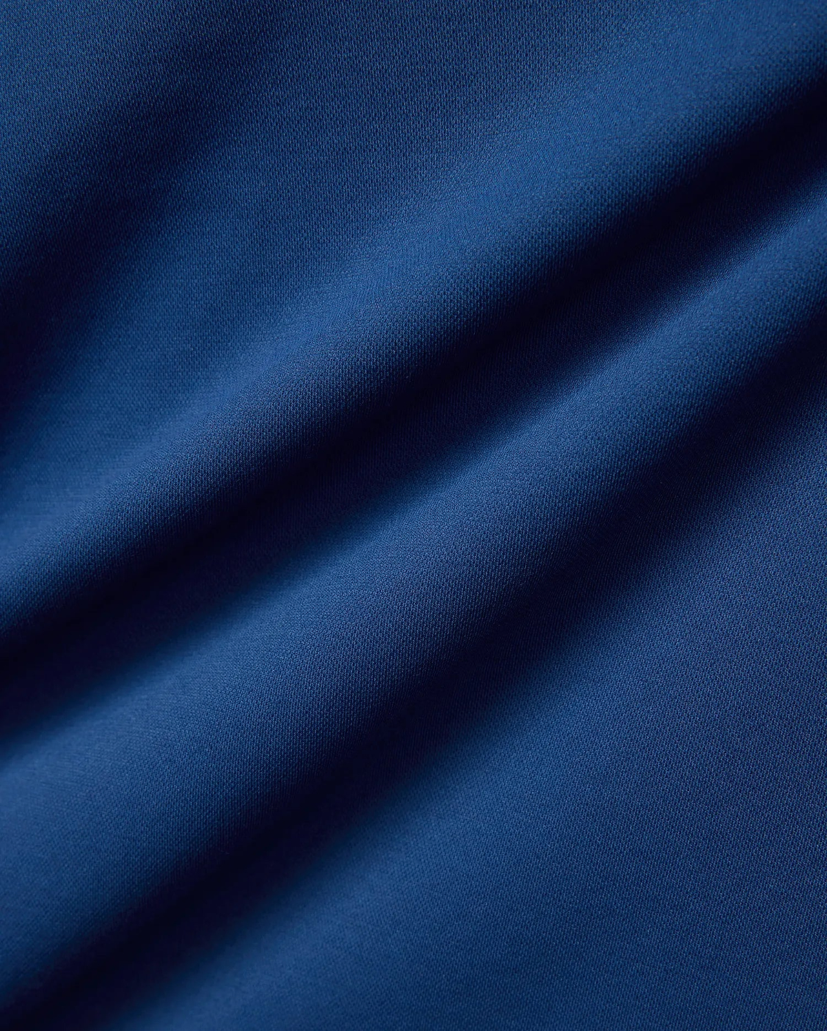 Psycho Bunny Mens Joji Performance Polo in deep blue, featuring a finely textured pique knit fabric, embodying refined streetwear style.