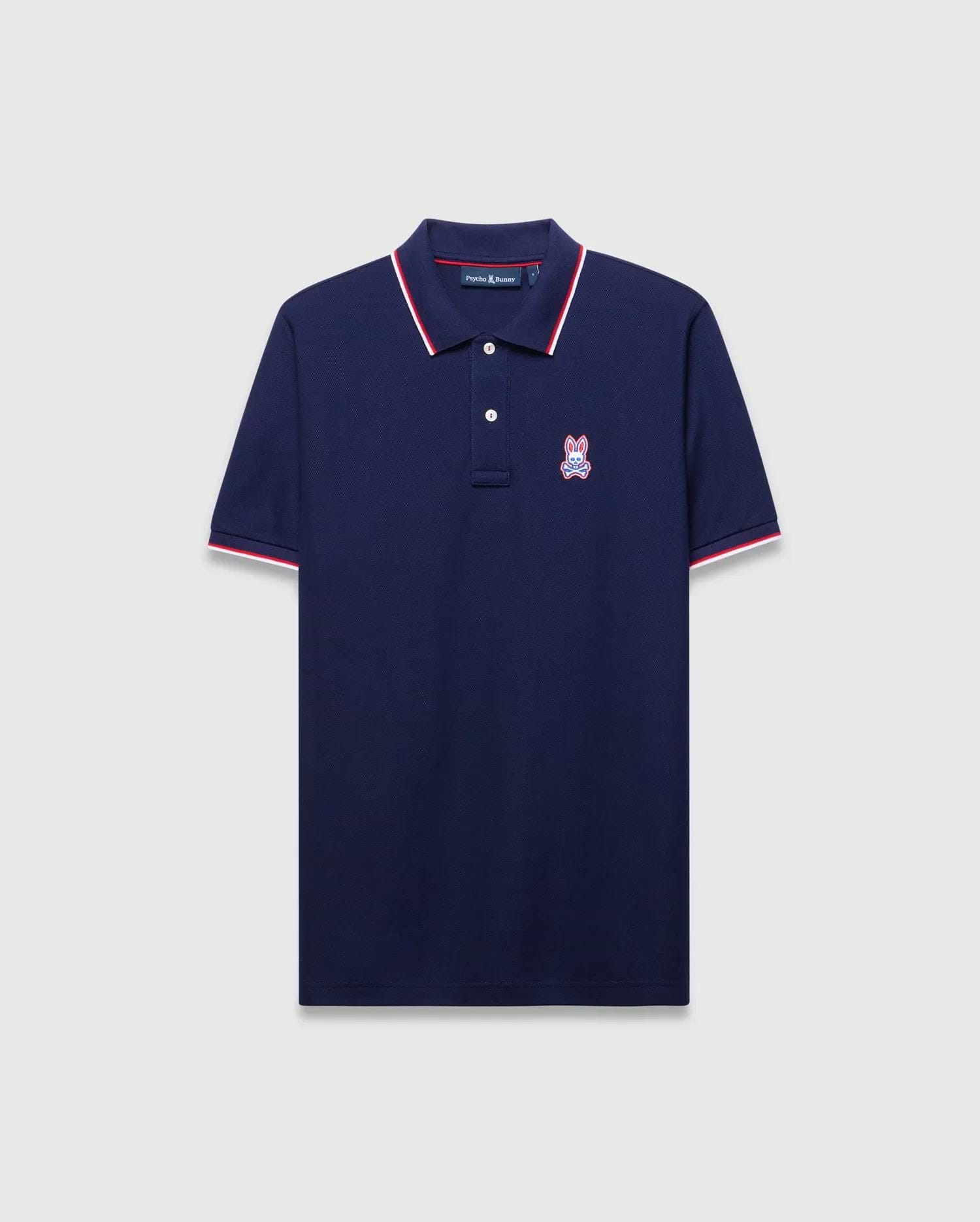Mens John Pique Polo, a classic fit navy pique polo with red and white tipped ribbed collar and cuffs, featuring an embroidered red, white, and blue Psycho Bunny skull logo on the left chest.