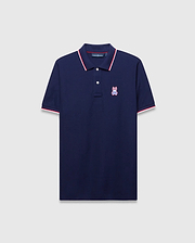 Mens John Pique Polo, a classic fit navy pique polo with red and white tipped ribbed collar and cuffs, featuring an embroidered red, white, and blue Psycho Bunny skull logo on the left chest.