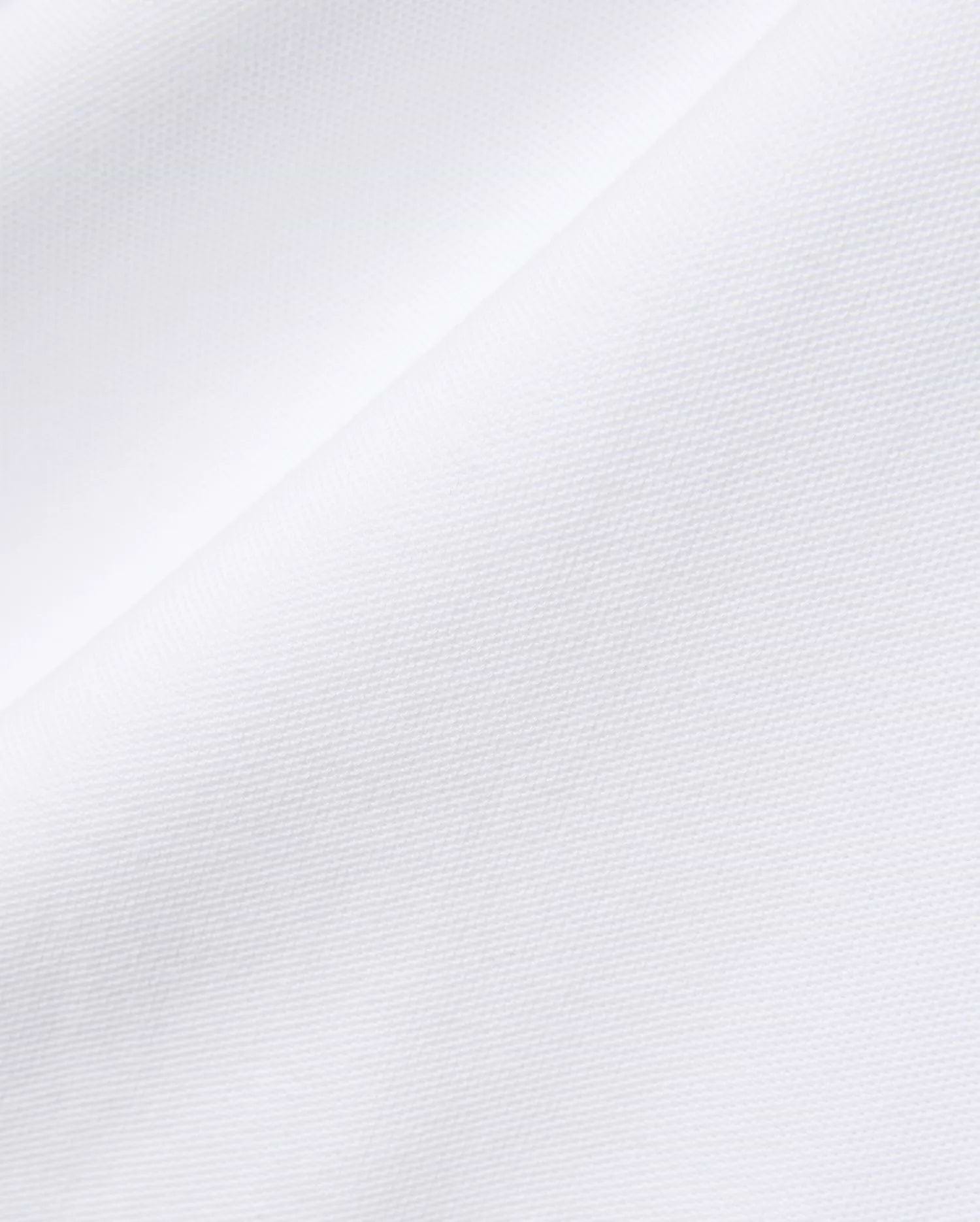Mens John Pique Polo in crisp white, crafted from breathable pique fabric, featuring the signature embroidered Psycho Bunny skull logo on the chest for a refined streetwear look.