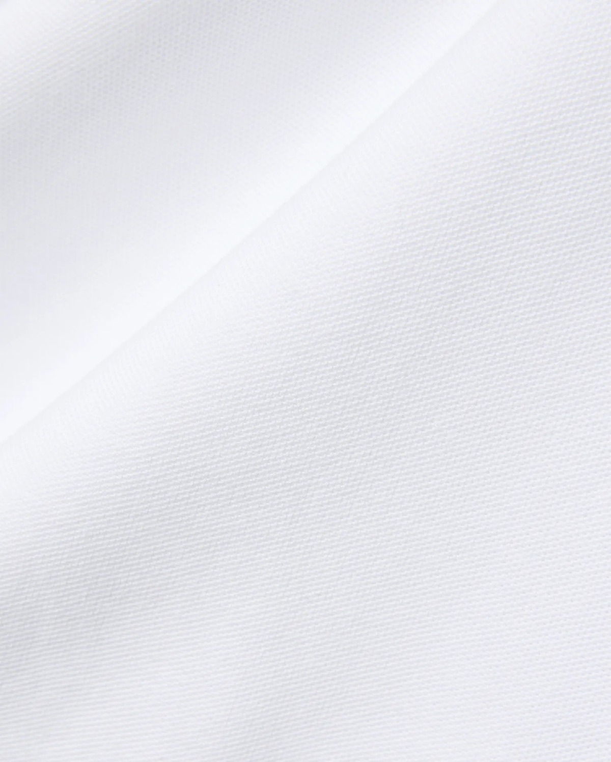 Mens John Pique Polo in crisp white, crafted from breathable pique fabric, featuring the signature embroidered Psycho Bunny skull logo on the chest for a refined streetwear look.