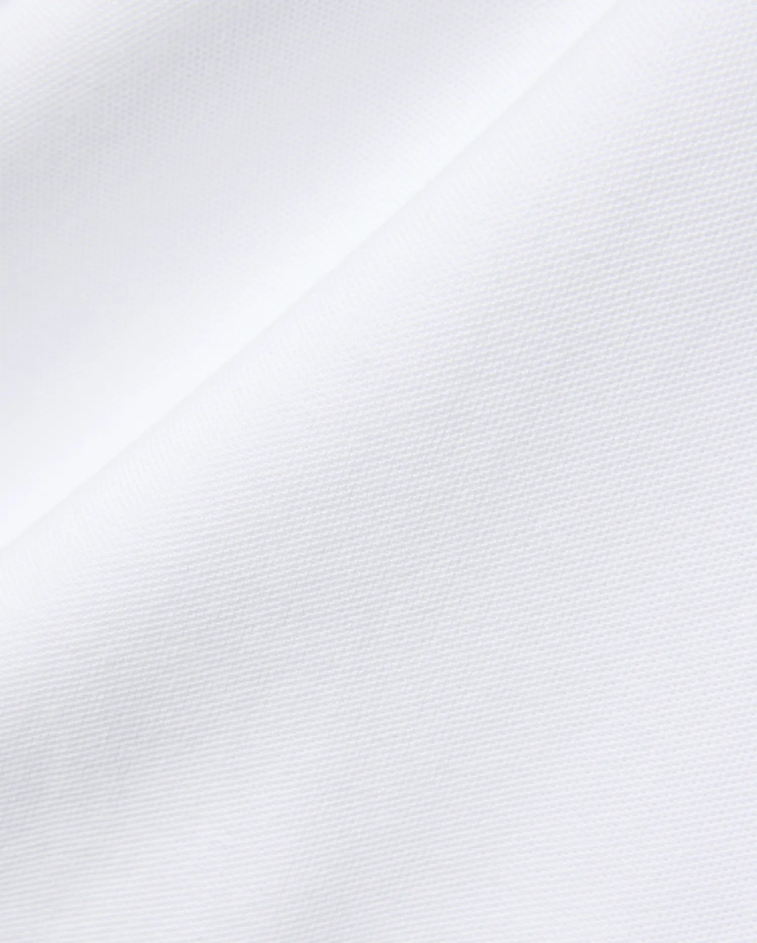 Mens John Pique Polo in crisp white, crafted from breathable pique fabric, featuring the signature embroidered Psycho Bunny skull logo on the chest for a refined streetwear look.