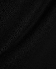 Black Mens Stan Pique Polo fabric, showcasing its premium, finely textured pique weave with subtle, elegant folds, ideal for refined streetwear.
