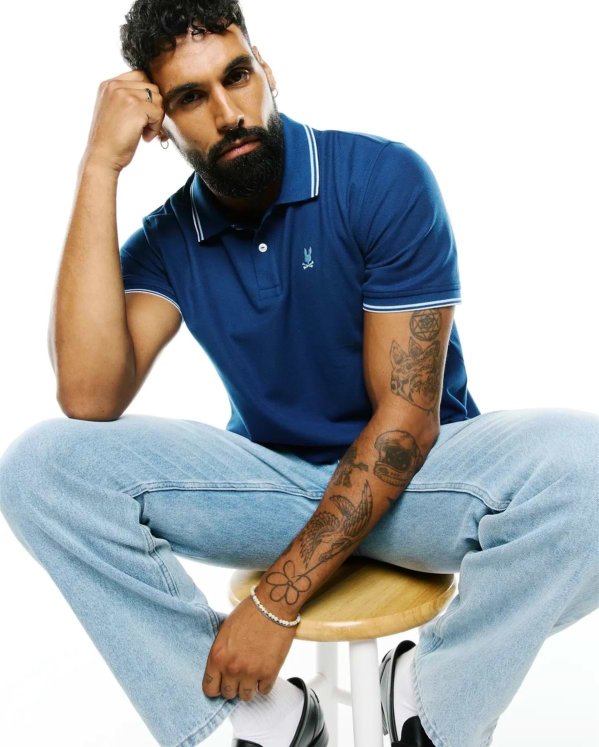 Royal blue MENS STAN PIMA PIQUÉ POLO, a classic fit pique polo with a two-button placket, ribbed collar and cuffs featuring white tipping, and a small embroidered Psycho Bunny skull logo on the left chest.