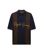 Mens Chad Relaxed Fit Striped Polo in navy and brown vertical stripes, featuring a relaxed fit, smooth jersey knit, large yellow embroidered Psycho Bunny script, and small embroidered skull logo.