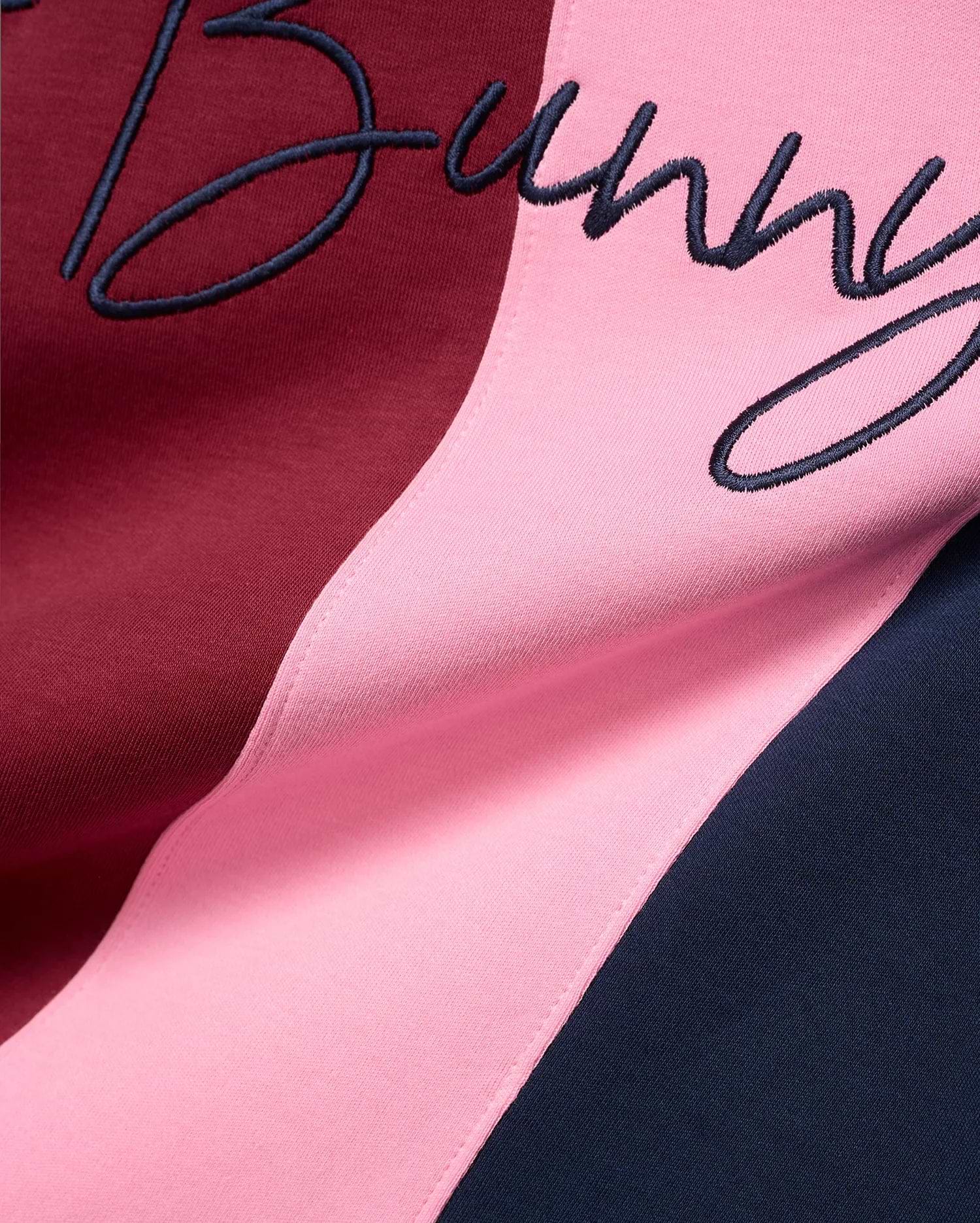 Mens Chad Relaxed Fit Striped Polo featuring bold vertical stripes in burgundy, pink, and navy blue jersey knit, with a large embroidered navy script Bunny logo.