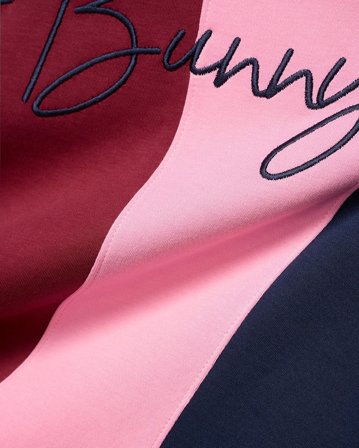 Mens Chad Relaxed Fit Striped Polo featuring bold vertical stripes in burgundy, pink, and navy blue jersey knit, with a large embroidered navy script Bunny logo.