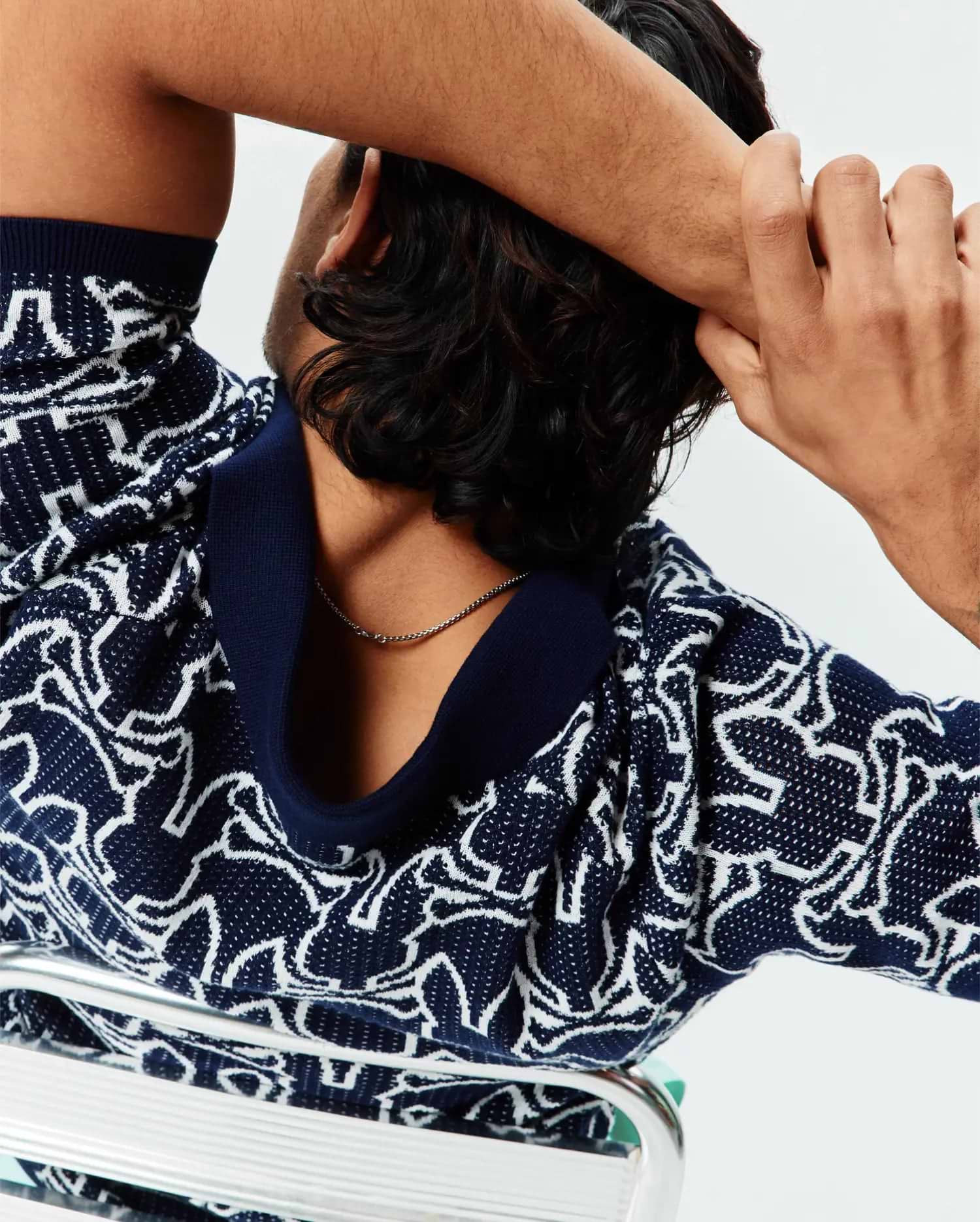Mens Sidney Oversized Knit Polo in navy blue with an all-over white abstract bunny skull pattern, featuring a relaxed fit and a solid navy ribbed collar.