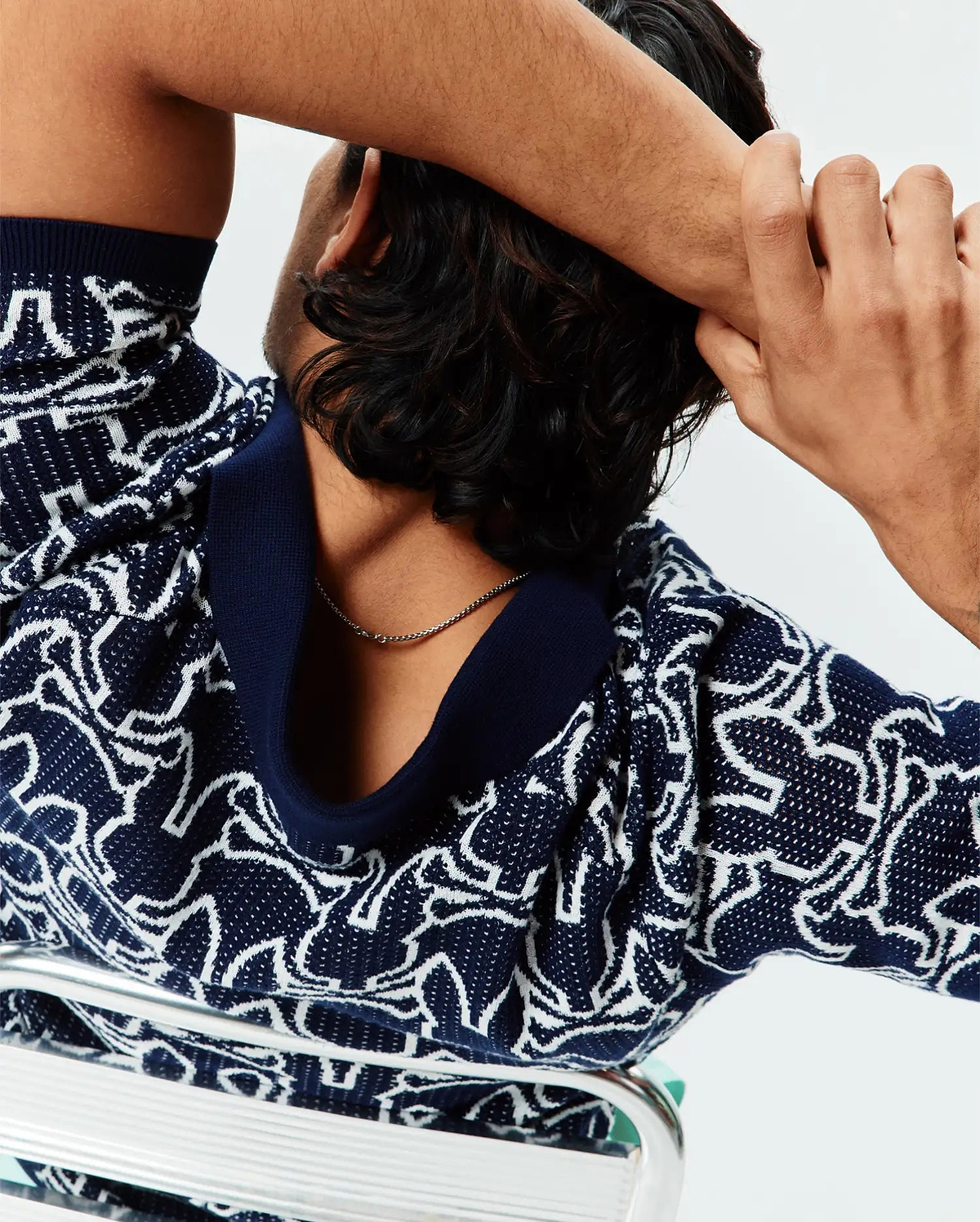 Mens Sidney Oversized Knit Polo in navy blue with an all-over white abstract bunny skull pattern, featuring a relaxed fit and a solid navy ribbed collar.