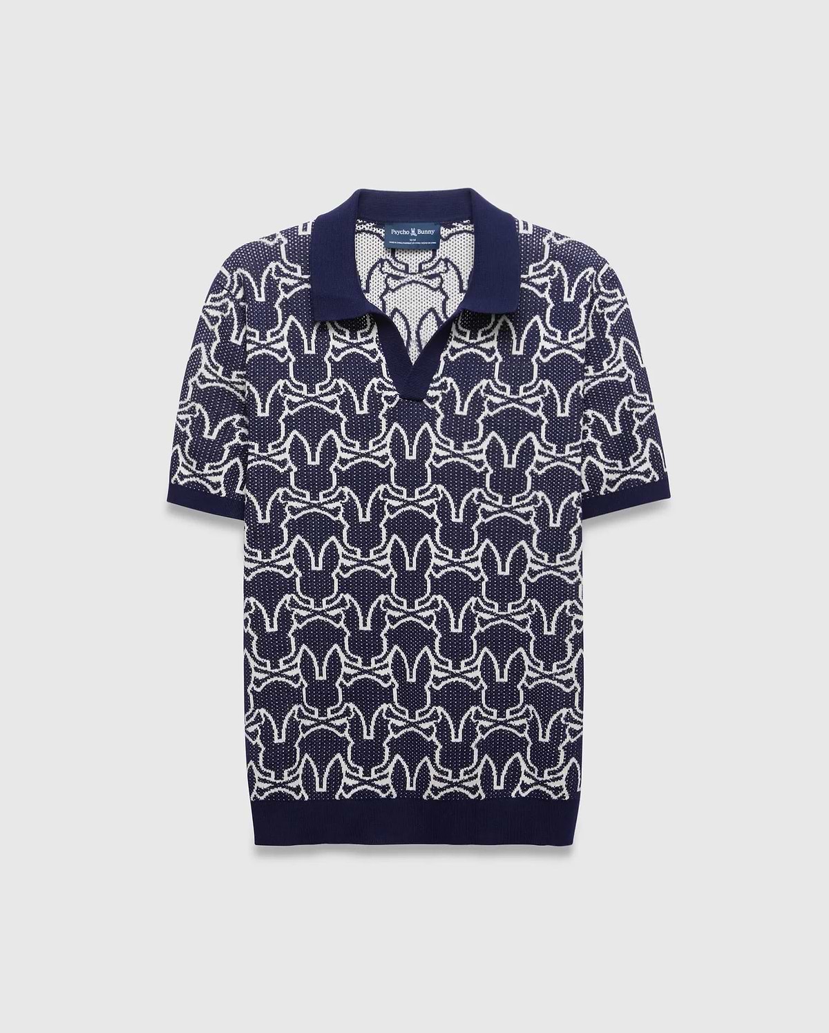 Mens Sidney Oversized Knit Polo in navy with a striking all-over white Psycho Bunny skull logo pattern, featuring a refined knit texture and classic collar.