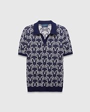 Mens Sidney Oversized Knit Polo in navy with a striking all-over white Psycho Bunny skull logo pattern, featuring a refined knit texture and classic collar.