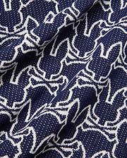 Mens Sidney Oversized Knit Polo in deep navy, featuring an all-over white outline Psycho Bunny skull logo pattern on a fine, textured knit fabric, offering a relaxed fit.