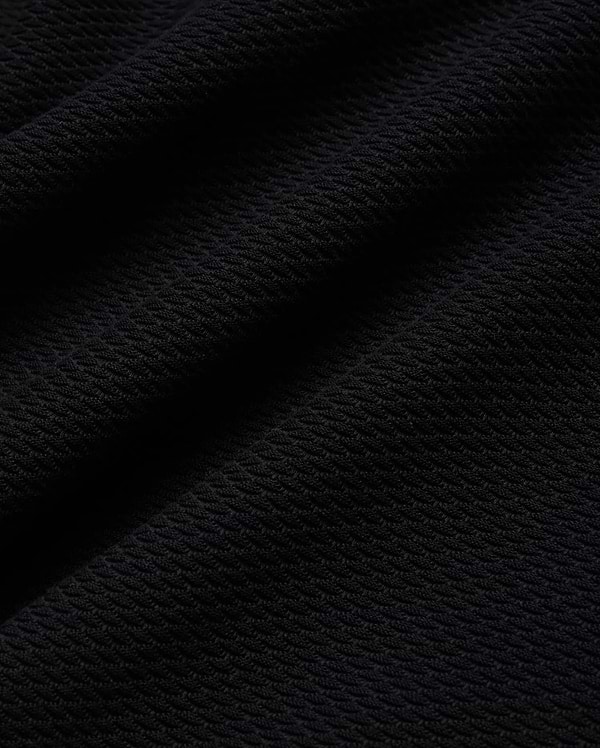 Mens Selby Knit Polo in deep black, showcasing a luxurious, finely textured knit fabric with a subtle, sophisticated diagonal pattern, ideal for refined streetwear. (5)