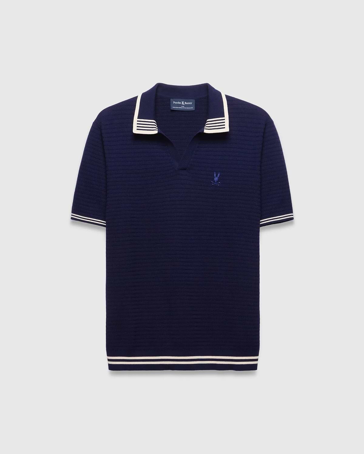 Mens Elowen Knit Polo in navy, featuring a textured knit fabric, white striped collar, cuffs, and hem, with a small embroidered Psycho Bunny skull logo on the left chest.